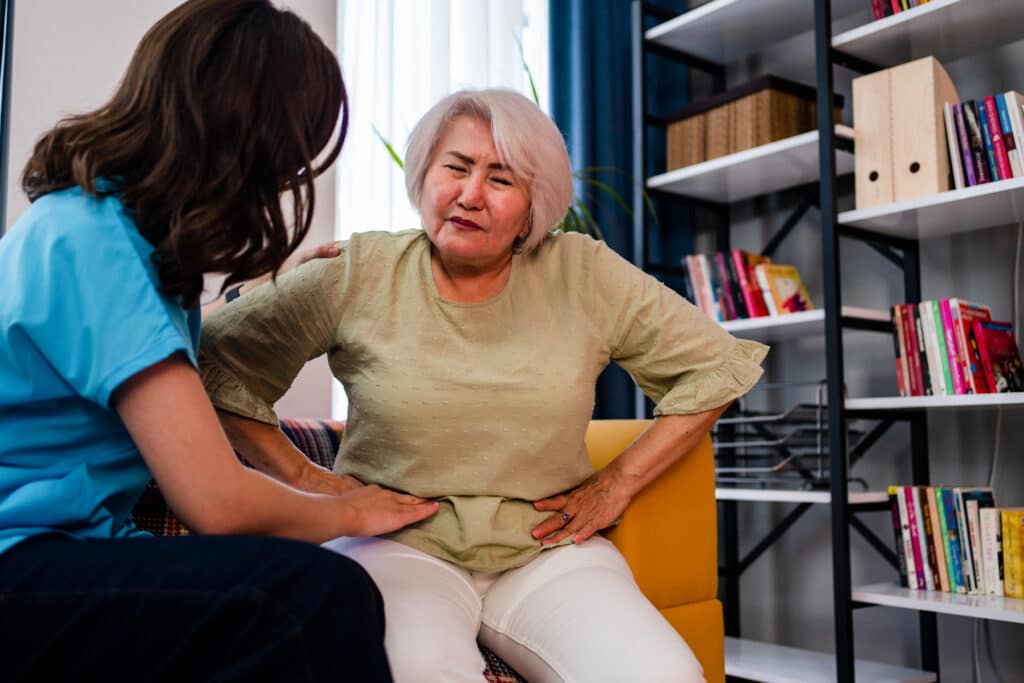 Doctor examines and comforts hernia patient.