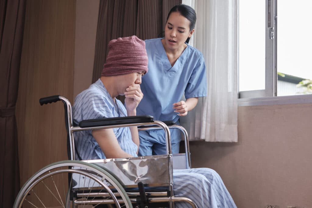 A patient suffering from mesothelioma coughing in the hospital.